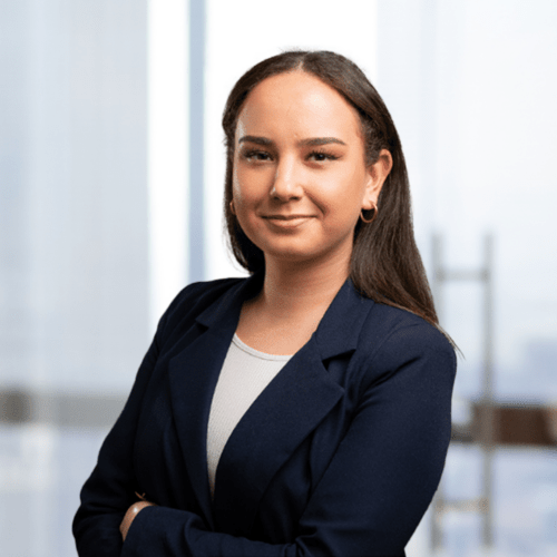 a woman with dark hair wearing a dark suit