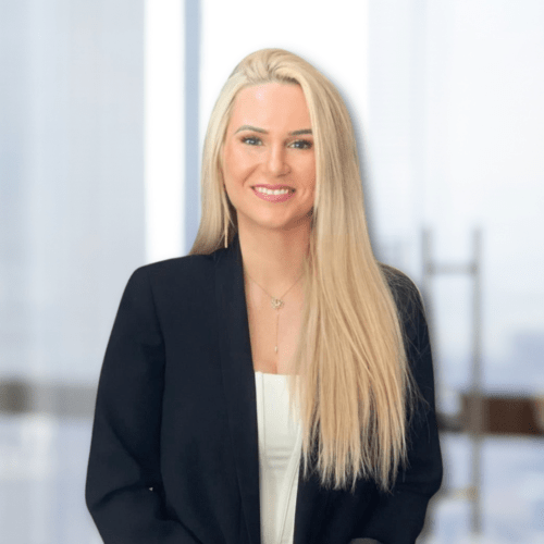 a woman with long blonde hair wearing a black jacket