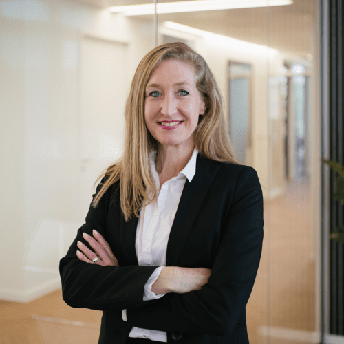 Carolina Heltzel a woman in a suit with her arms crossed