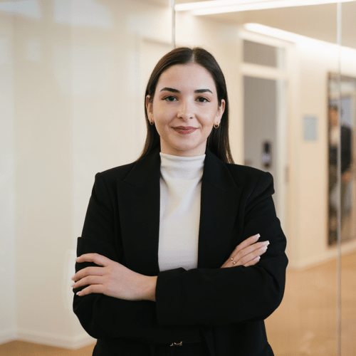 Flavia D'Alessandro a woman in a suit with her arms crossed