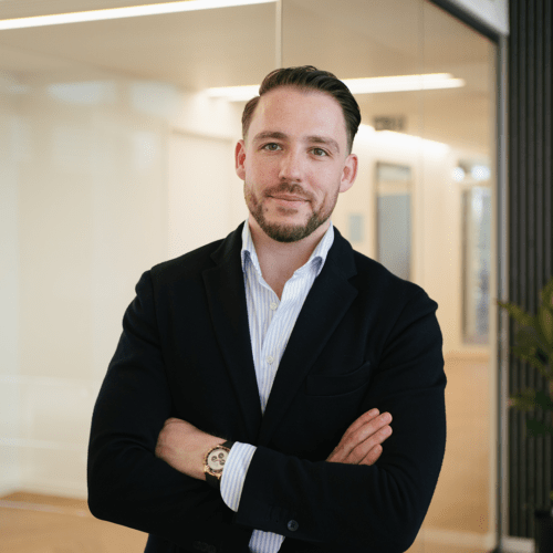 Johannes Wiedemann a man in a suit with his arms crossed