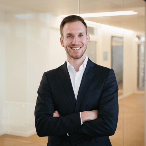 Leon Hanel a man in a suit with his arms crossed