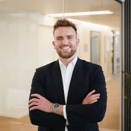 Lukas Roßkopf a man in a suit with his arms crossed