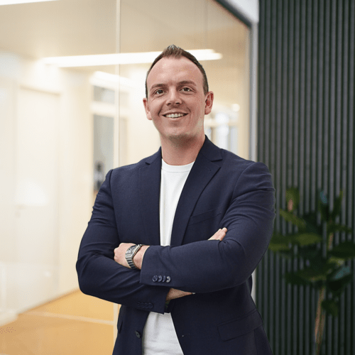 Marcel Mayer a man in a suit with his arms crossed