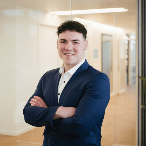 Maximilian Grüssmer a man in a suit with his arms crossed