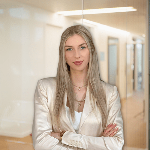 Ramona Lukas a woman in a white suit with her arms crossed